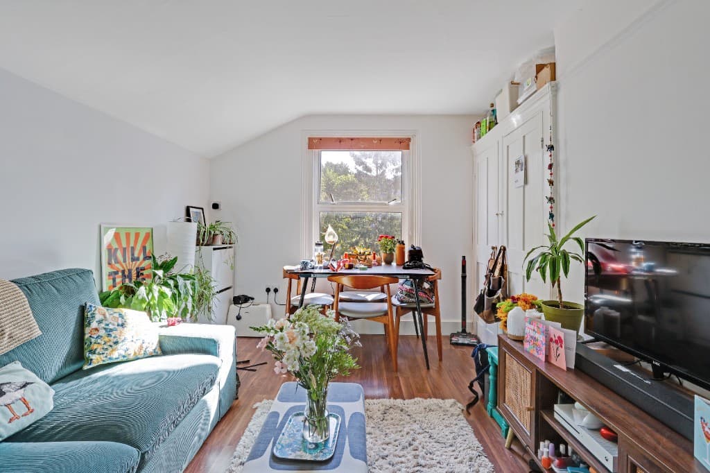 Lived-in living room with clutter on tables and surfaces