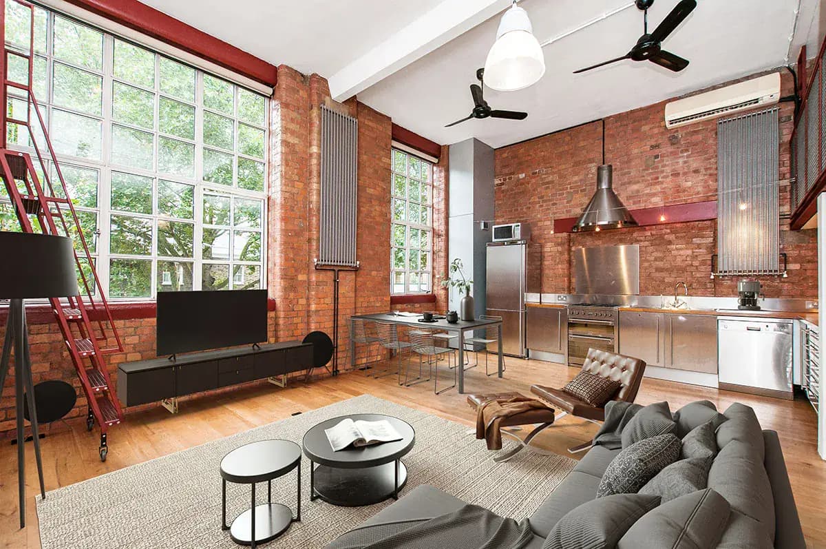 Stylish industrial-style loft apartment with exposed brick and large windows