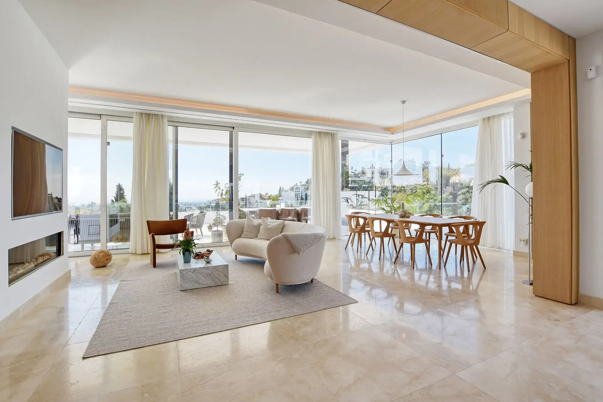 Bright modern open-plan living and dining room with floor-to-ceiling windows